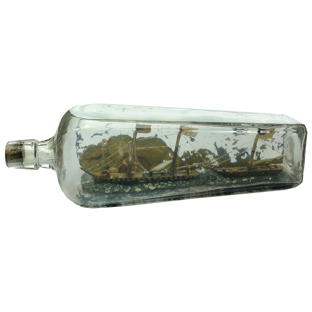 Ships in a bottle. Early clear Gin with two ships, lighthouse scene built inside.