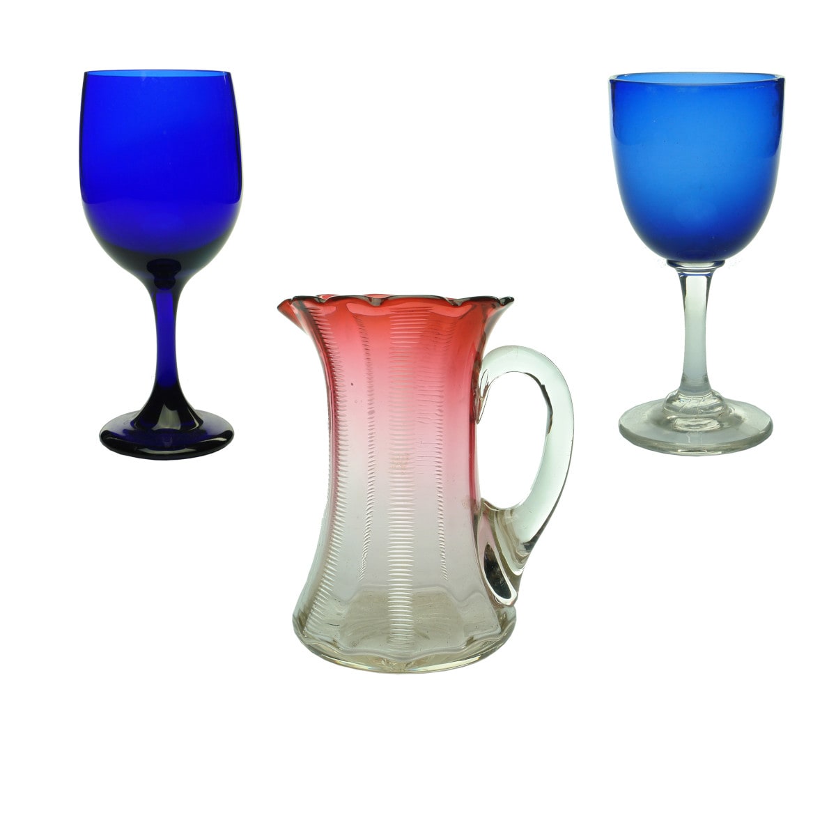 3 items. Two Glasses & a Jug: Blue Wine Glass and Victorian Bristol Blue Wine Glass with clear stem. Handled Ruby Jug.