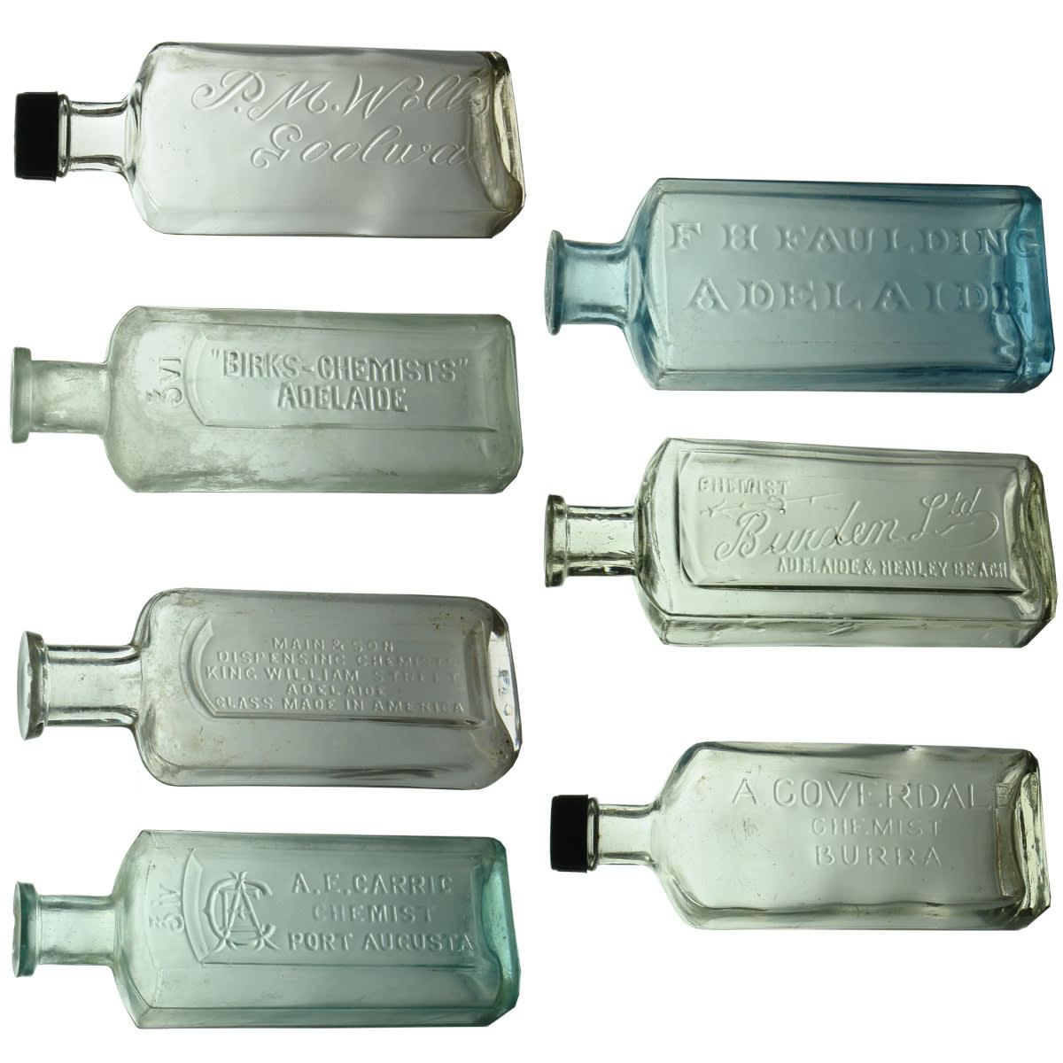 7 South Australian Chemist Bottles: Carrig, Port Augusta; Main & Son, Adelaide; Birks; P. M. Wells, Goolwa; A. Coverdale, Burra; Burden, Henley Beach; Faulding. (South Australia)