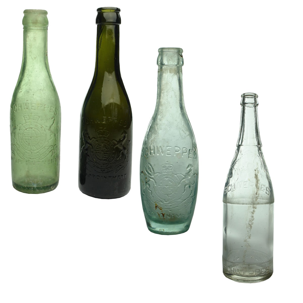 Four Schweppes Crown Seals: Black, Light Green, Skittle and large with fruit at shoulder.