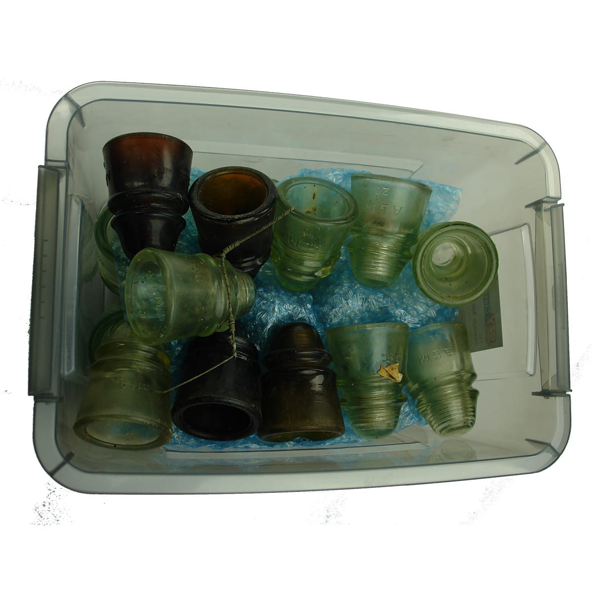 25 Glass Insulators: CD423. 7 x Clear; 14 x Aqua; 4 x Amber.