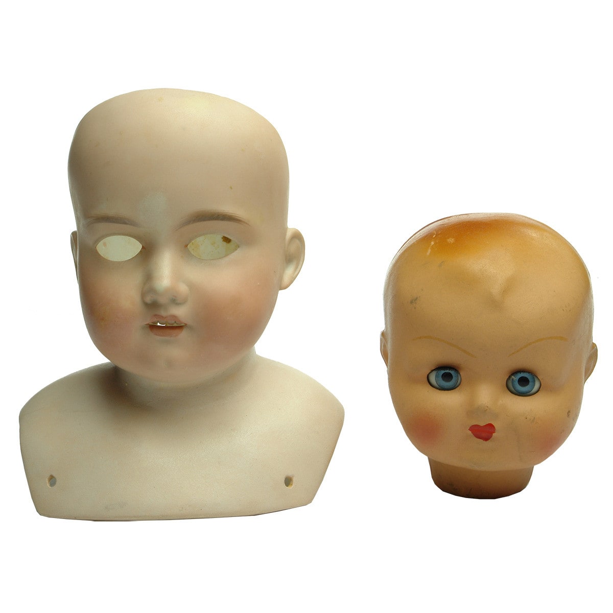 Dolls. Large shouldered bisque doll's head and a large rubberoid or celluloid doll's head.