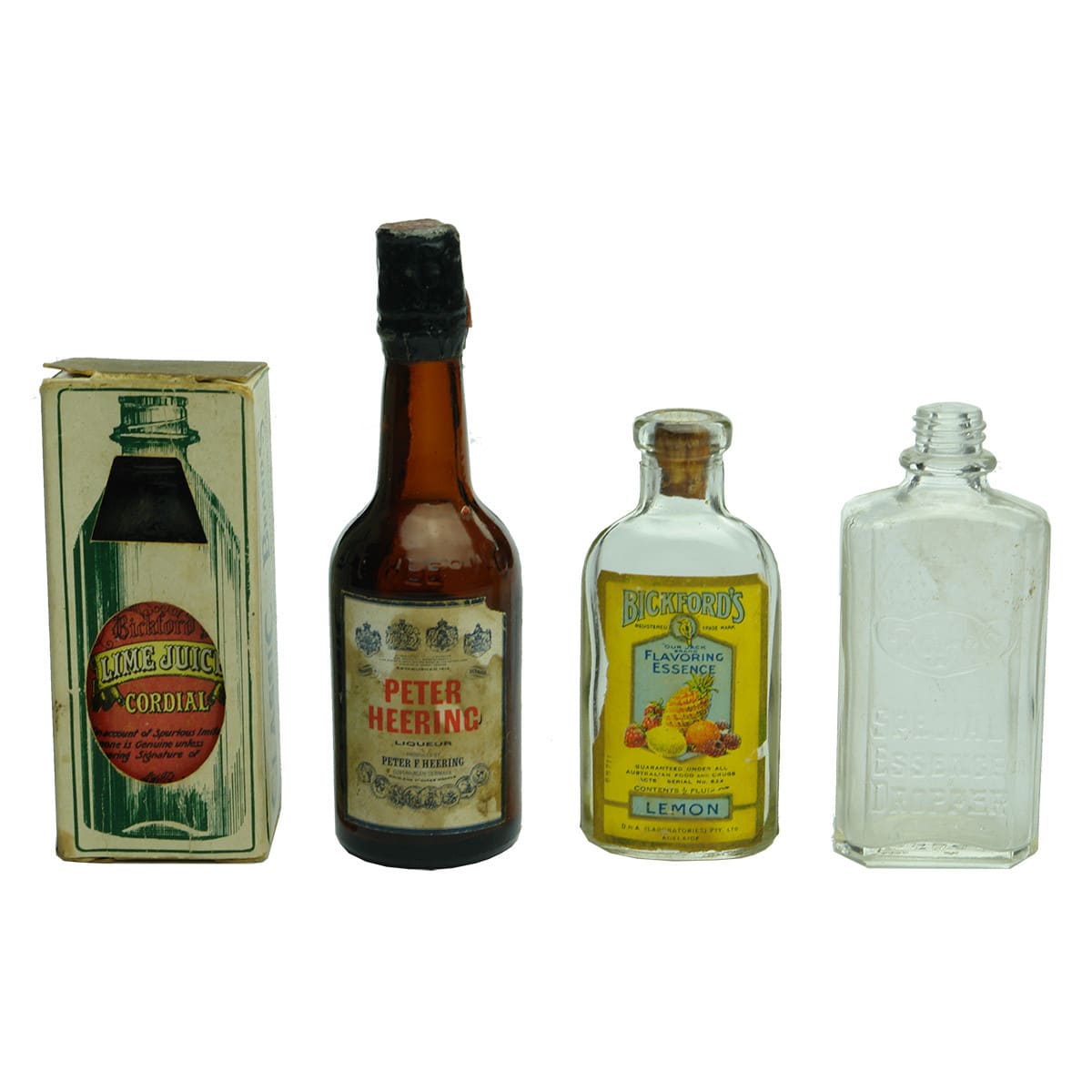 Four Sample/Essence bottles: Peter Heering; Modern Bickfords Lime Juice Cordial; Rolfe's Essence; Bickford's Lemon Essence.