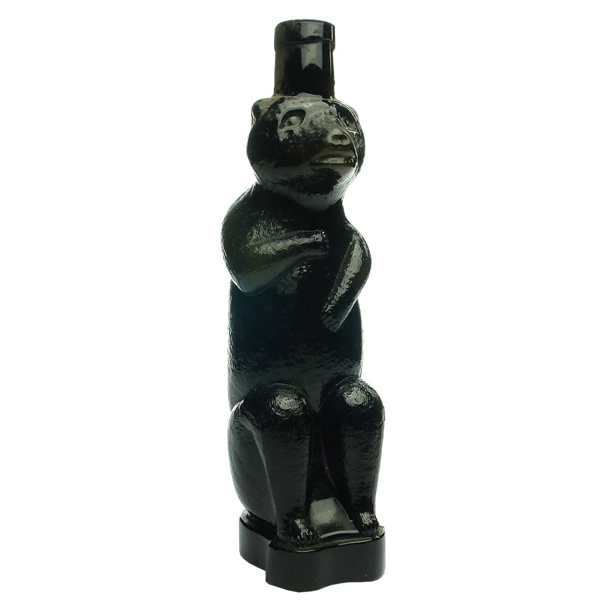 Figural Kummel Bottle. Sitting Bear. Very dark green. Applied top. Parts of early labels.