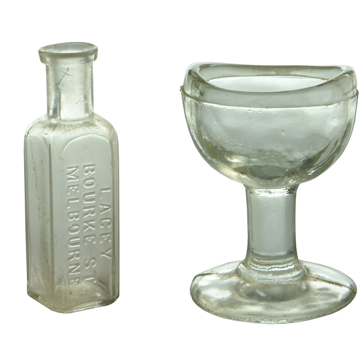 2 Items Chemist Bottle & Eye Bath. Lacey, Bourke St., Melbourne; Clear glass pedestal eye bath. No markings.