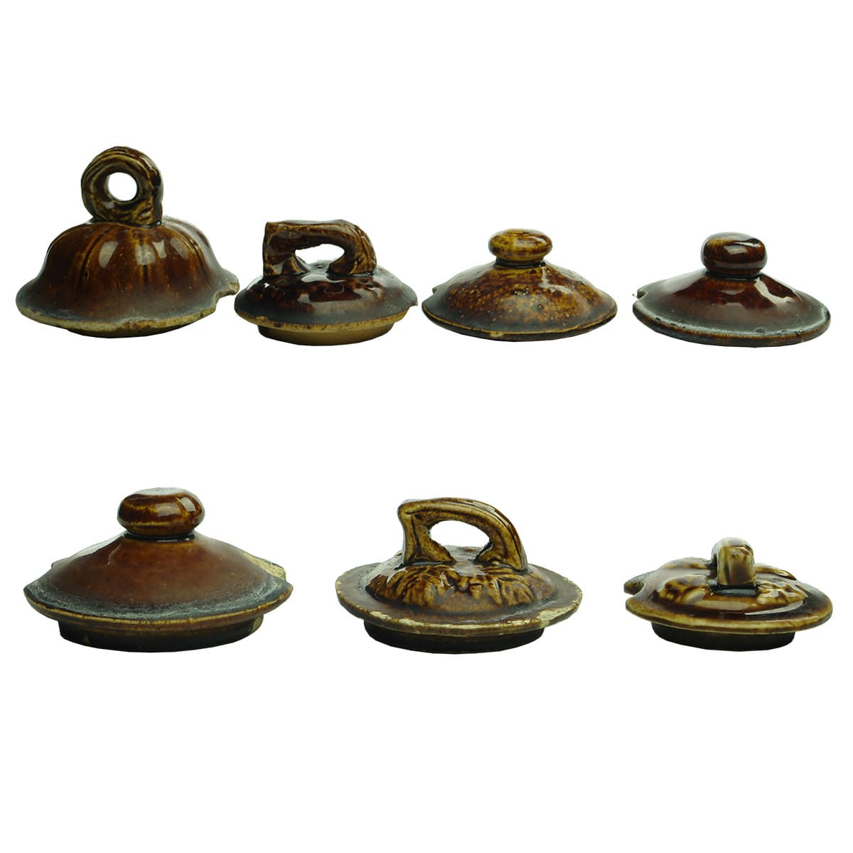 7 Teapot Lids. Rockingham glaze. Different patterns and various sizes.