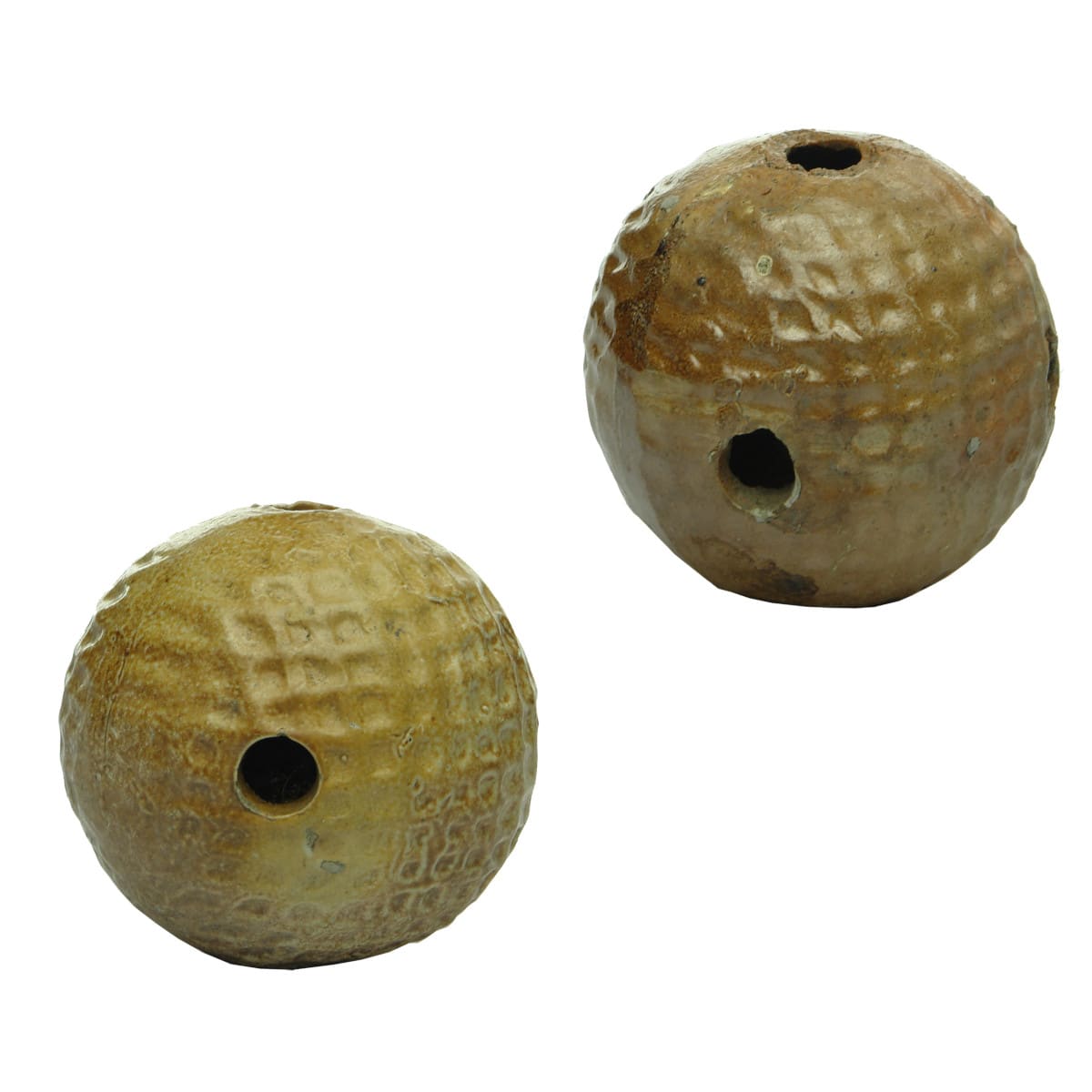 Pair of Ceramic Balls. Almost like golf balls. Holes around top and bottom and four around the middle.