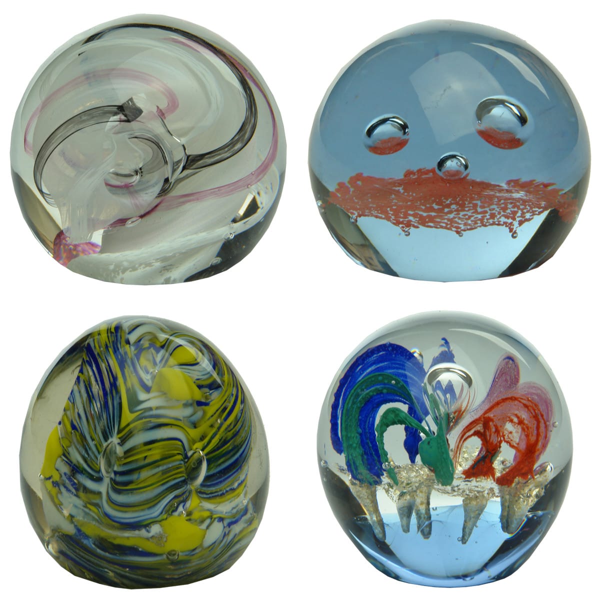 4 Glass Paperweights. White, Black & Pink swirled, Caithness Ribbons Scotland; Pink, CIIC; Egg, Yellow, Blue & White; Round, Green, Red, Pink & Blue.
