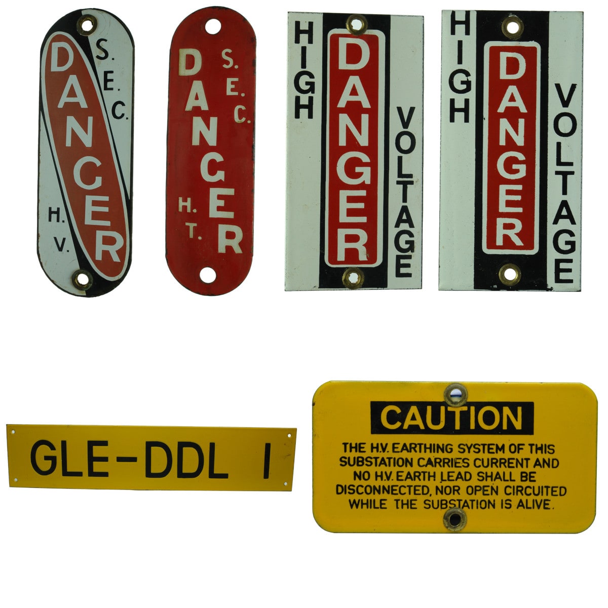 Six small enamel signs: 2 x SEC Danger; 2 small Danger High Voltage; GLE-DDL 1; Caution, Substation notice.