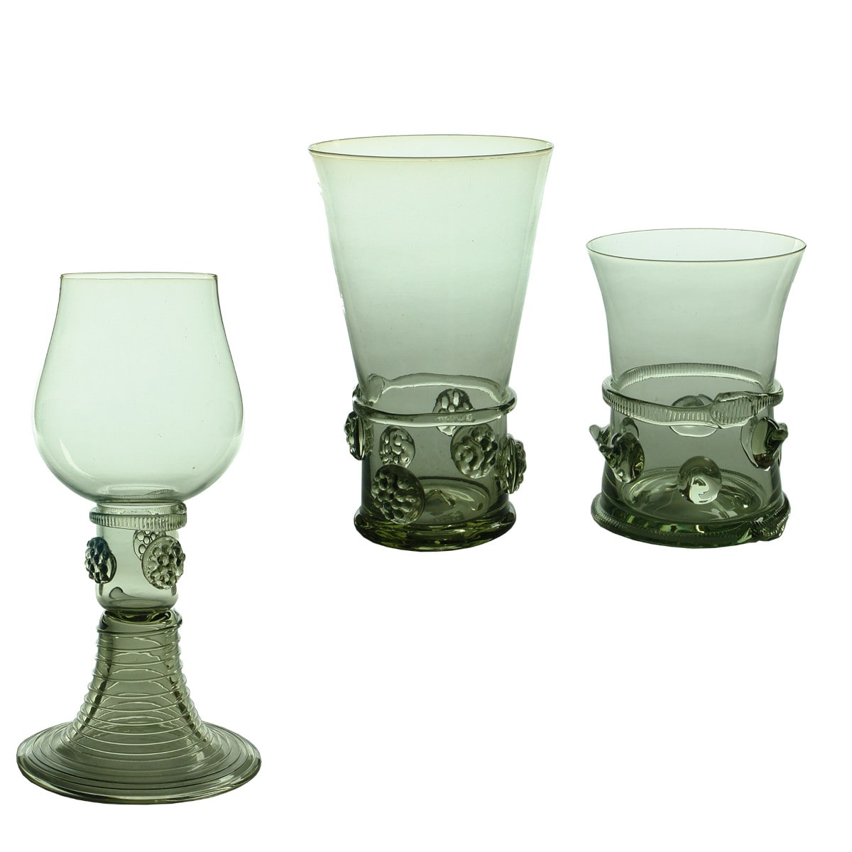 Three glasses. All quite different but all have an etched sto8 or similar mark on the base. Applied decoration and pale green aqua.