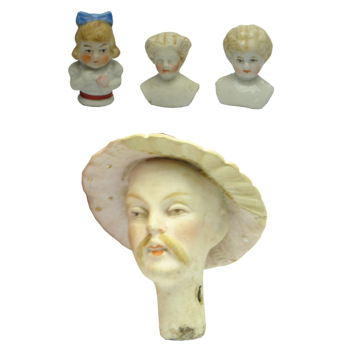 Dolls. Four dolls heads including a bonnet doll and an Asian type bobble head.