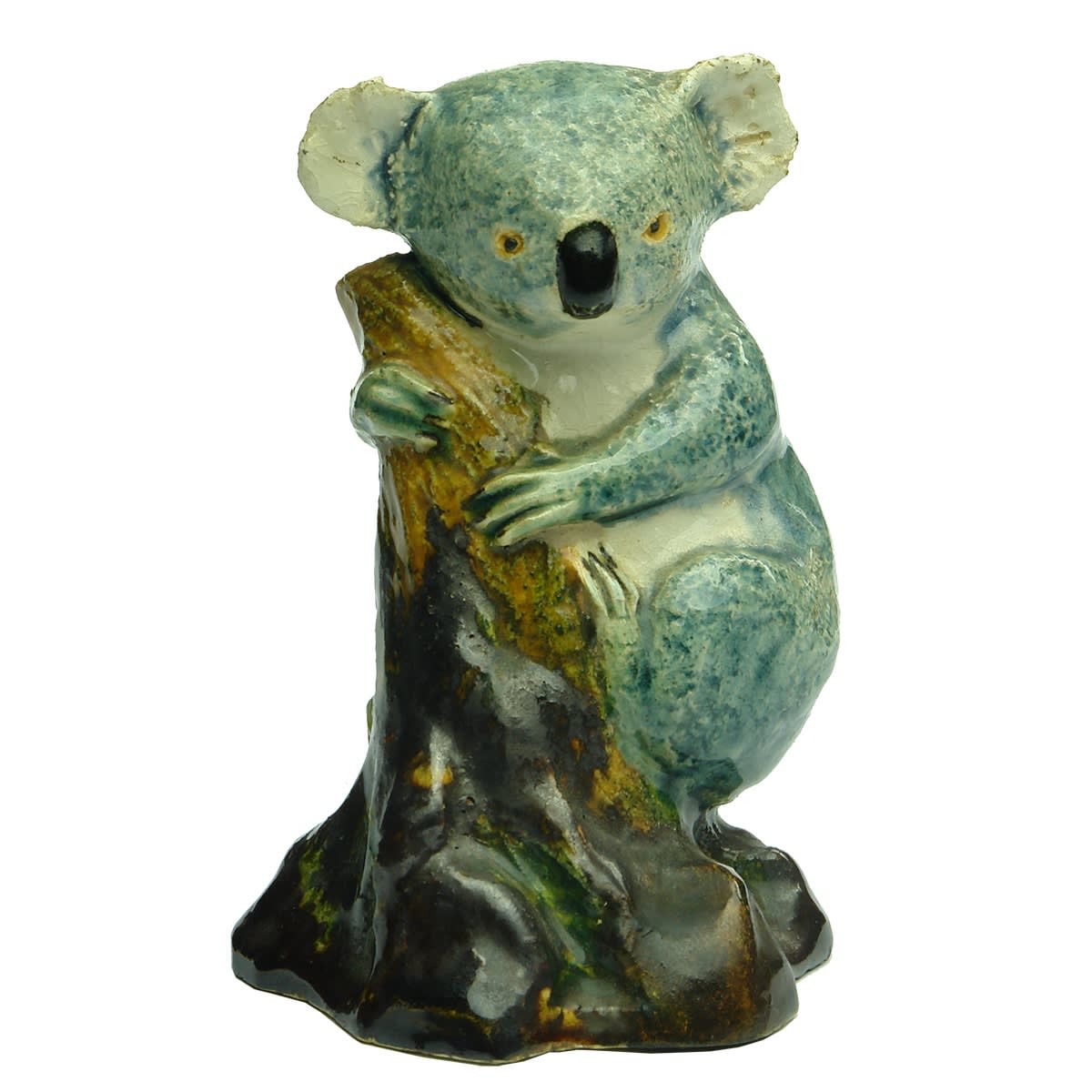 Pottery. Koala on tree stump. Grace Seccombe printed to base as well as a moulded knot in a circle mark.