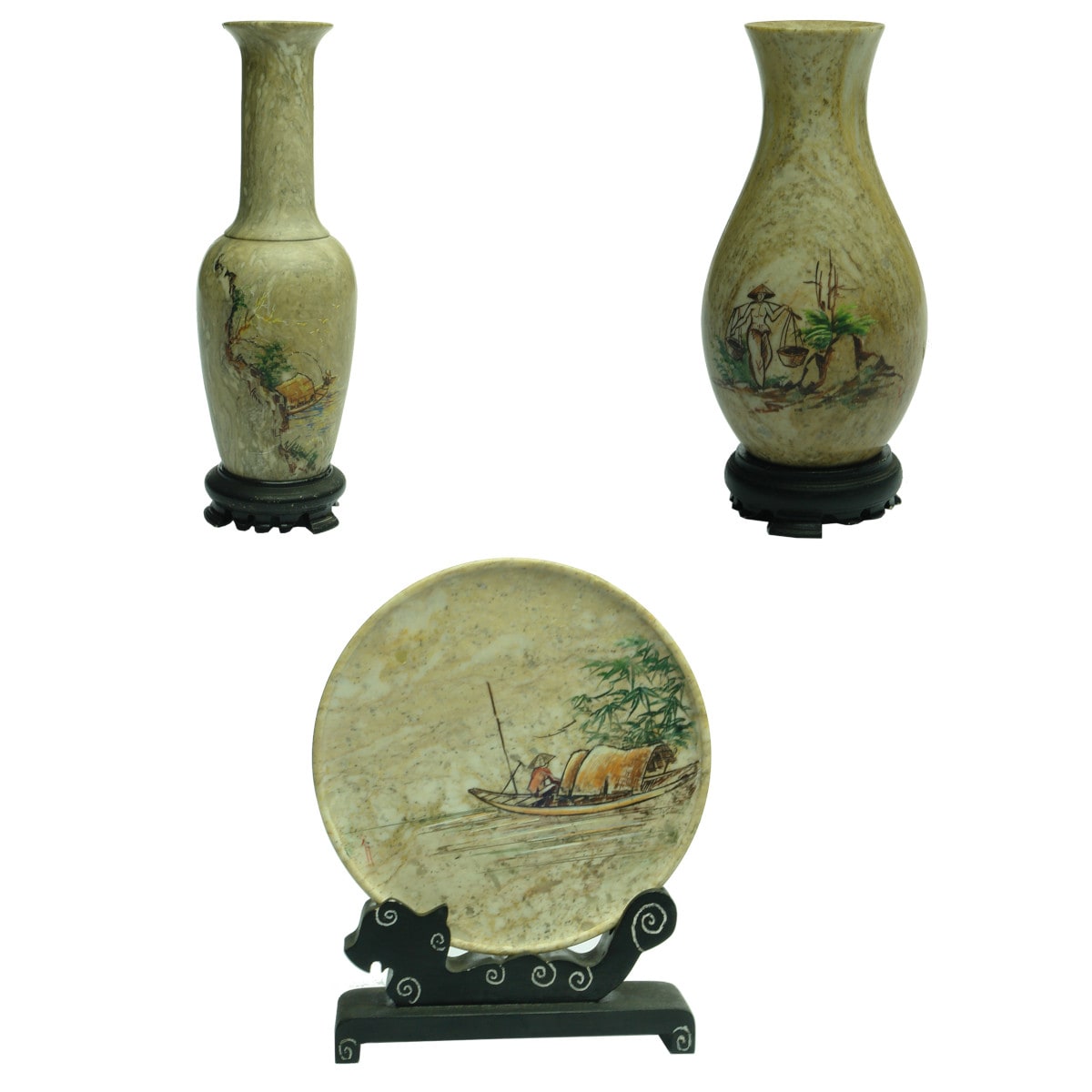 Set of 3 carved and polished stone pieces with stands. 2 vases and a plate. Rural scenes carved and coloured in the main pieces.