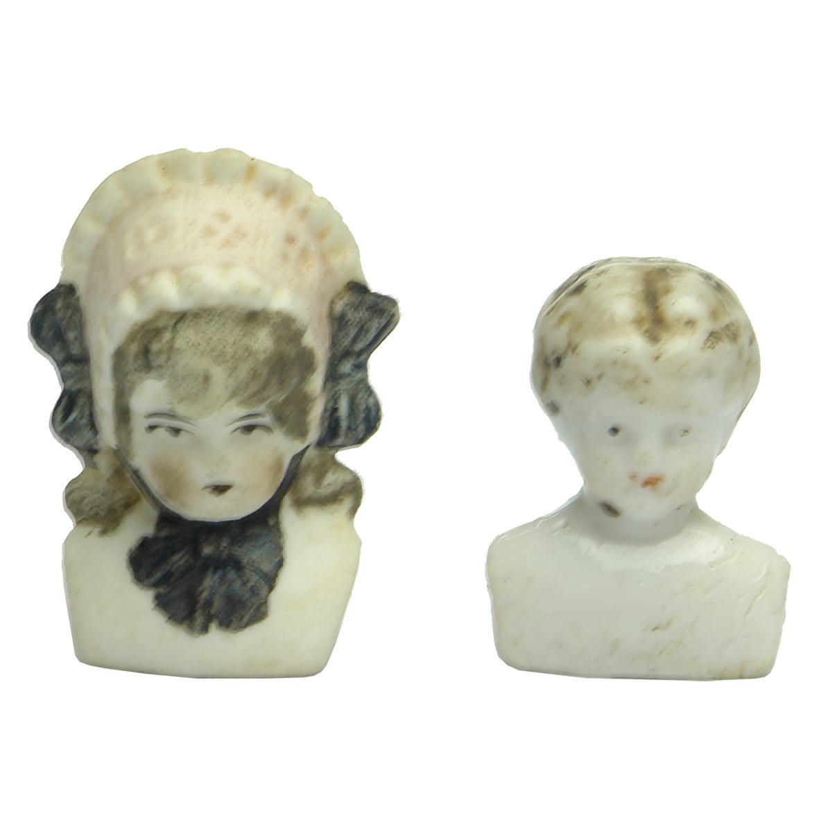 Dolls. Pair of small doll's heads including a bonnet doll.