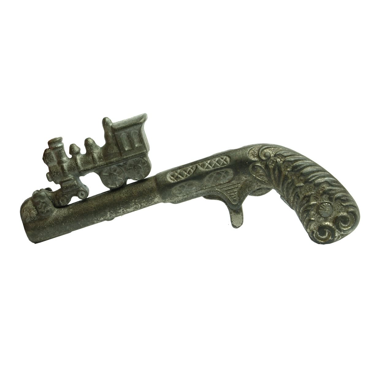 Toy Cap Gun. Locomotive is coiled and then "shot" into the cap. Similar to Lightning Express but not embossed with the name.