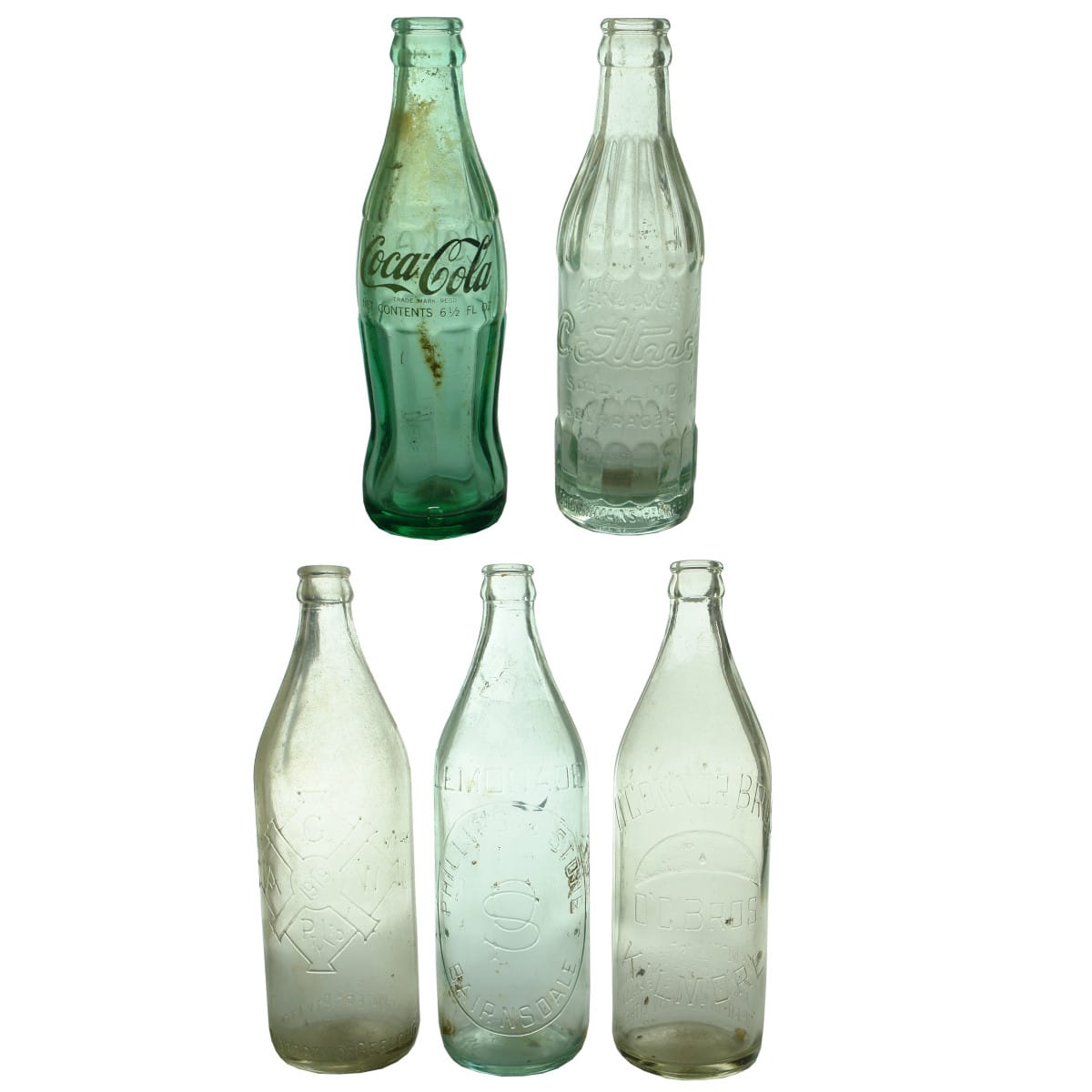 Crown Seals. 1. Coca Cola. Hobble skirt. Ceramic Label. Aqua. 6 1/2 oz. 2. Cottee's Passiona. Aqua. 6 1/2 oz. 3. Geelong Aerated Waters. Clear. 24 oz. 4. Phillips & Stone, Bairnsdale. Aqua. 24 oz. 5. O'Connor Bros., Kilmore. Clear. 24 oz.