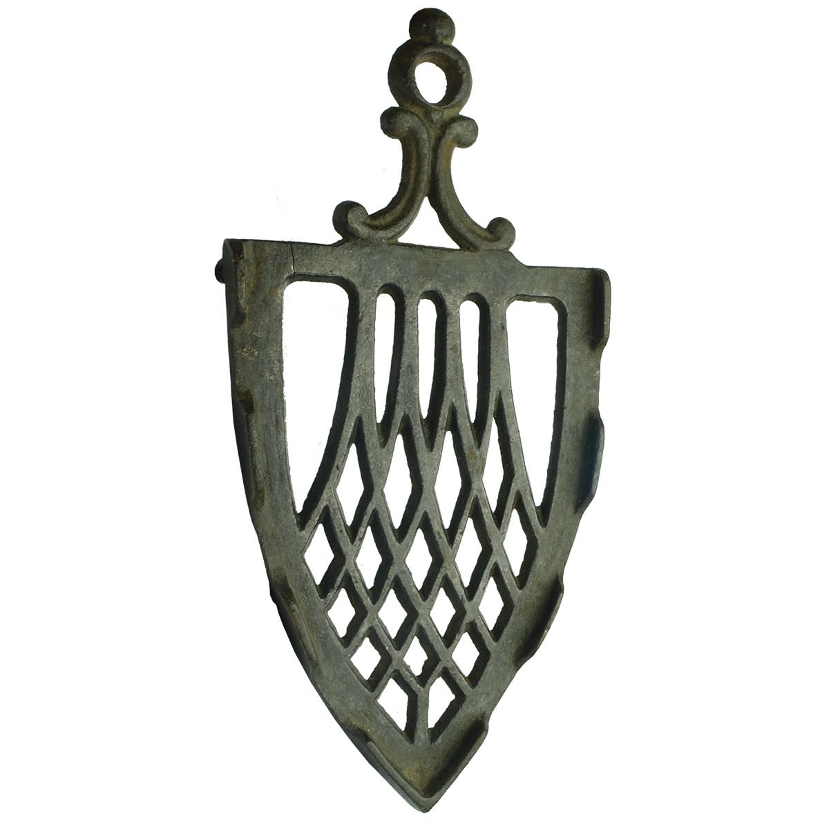 Metalware. Ornate cast iron trivet.