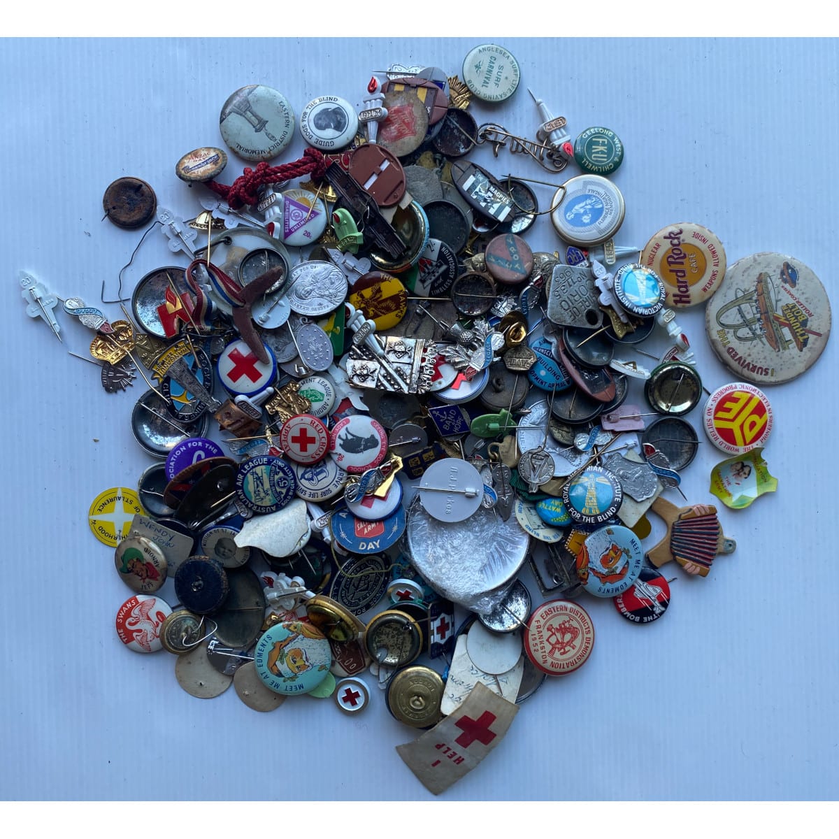 Tin of badges, buttons and more. Early 1900s - Early 2000s. Tin: Mackintoshs Quality Street 1936-1986. Plus more badges, keyrings etc.