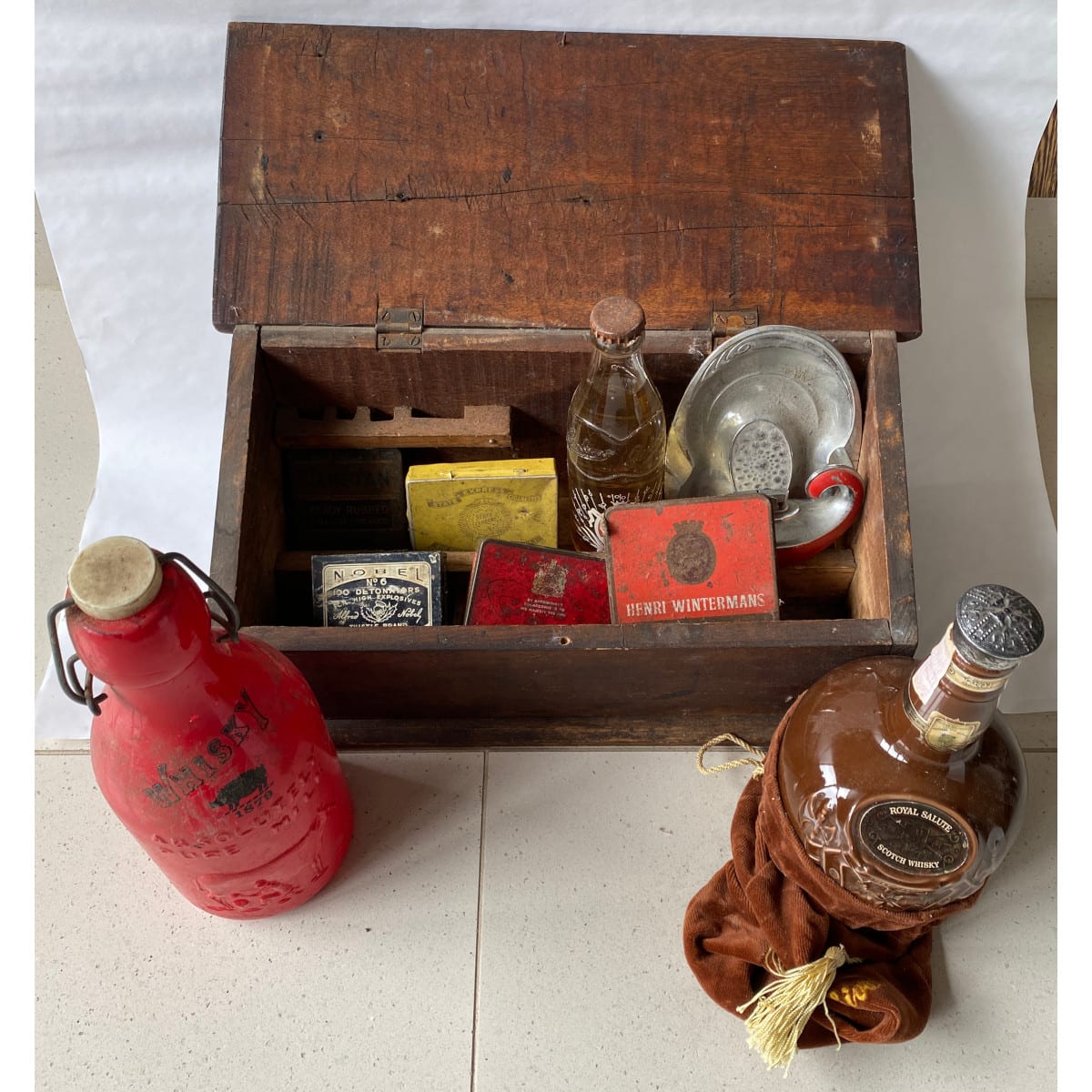 Group of oddments: Small timber artists box Spode Ceramic Chivas Regal bottle in bag Modern Milk painted red, Whisky Cohns Ceramic Label crown seal 5 tins Genie lamp lighter & ashtray.