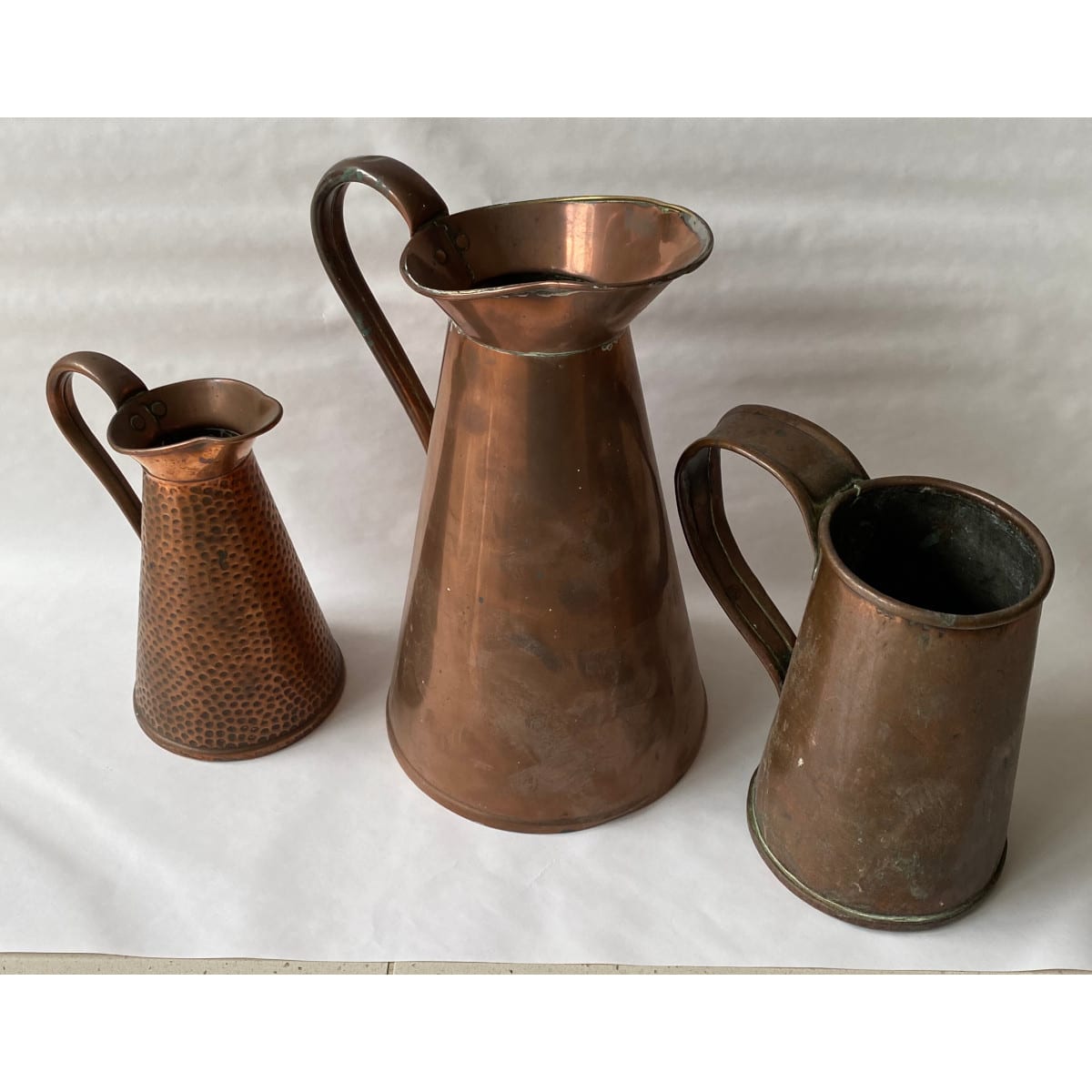 3 tall handled Copper Jugs.