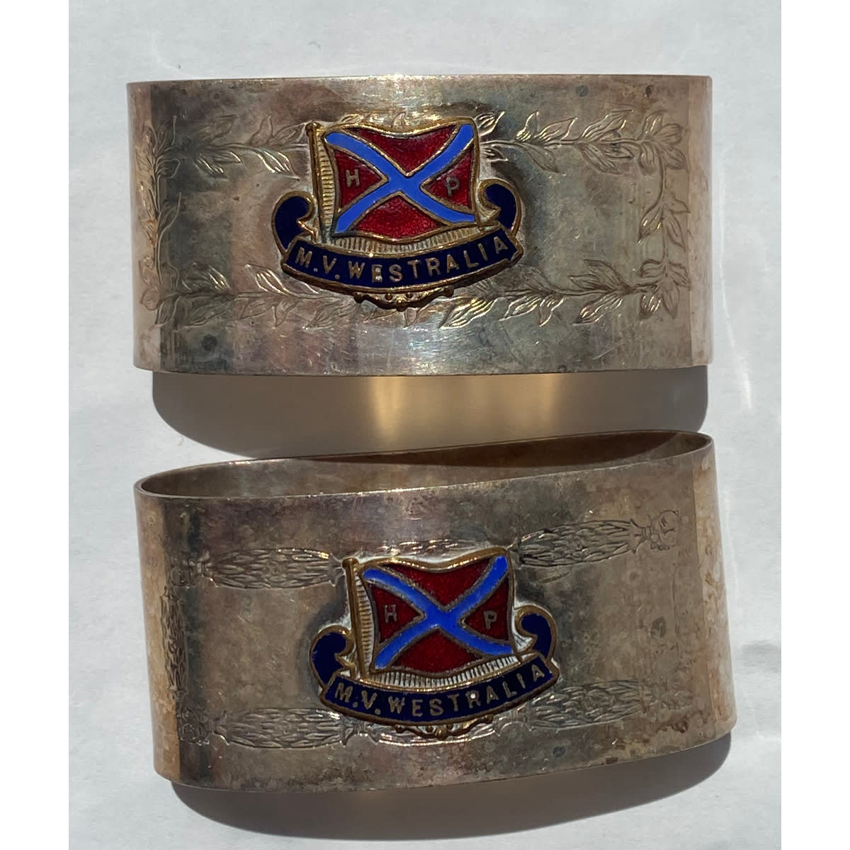 2 EPNS Serviette Rings. M. V. Westralia enamel badges.