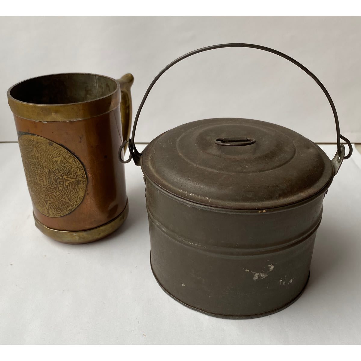 2 Metal Items. Mexican Brass & Copper Mug with fancy brass badge to the front. Small round lidded tin, early type.