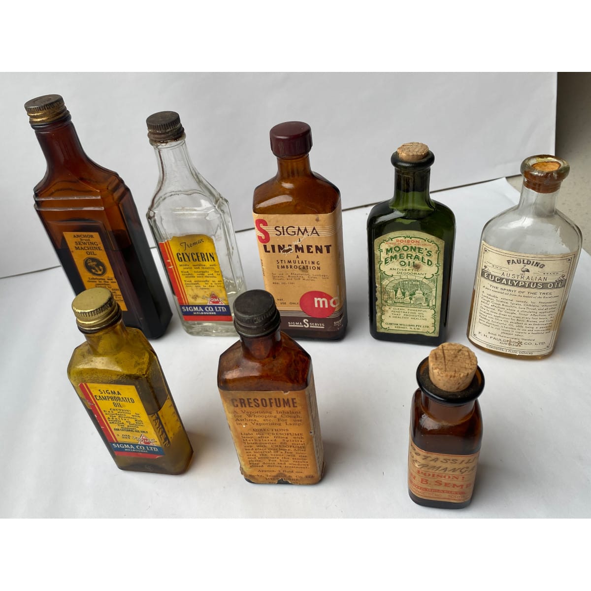 8 Labelled Bottles: Anchor Machine Oil 3 x Sigma Co Products Moone's Emerald Oil Fauldings Eucalyptus Rocke Tompsitt John B Sempiel.