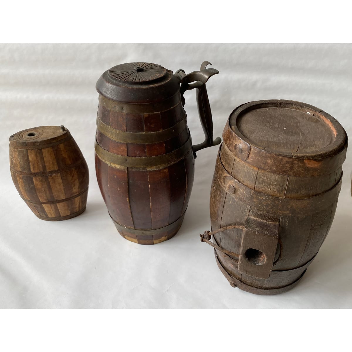 3 Wooden Barrel shaped items: Handled Stein with metal fittings Small barrel with EB in the end Oval powder flask with a barrel like look.