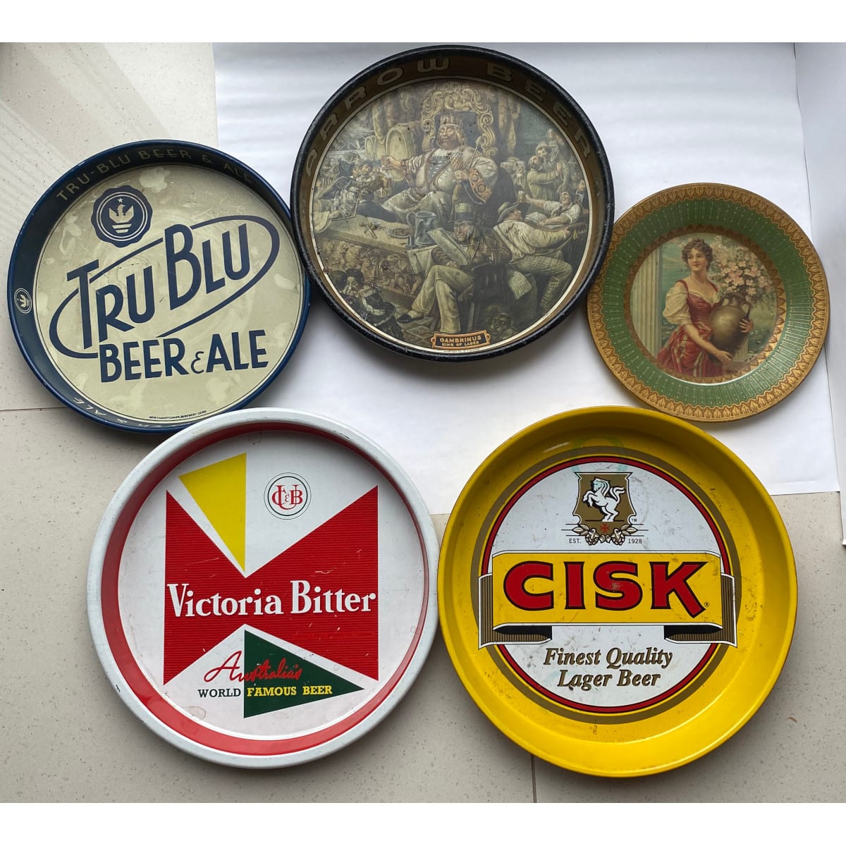 5 Metal Beer Advertising Trays: Victoria Bitter, CUB Tru Blu Northampton Globe Brewery Gambrinus Arrow Beer CISK Royal Saxony art plate Woman with Amphora.