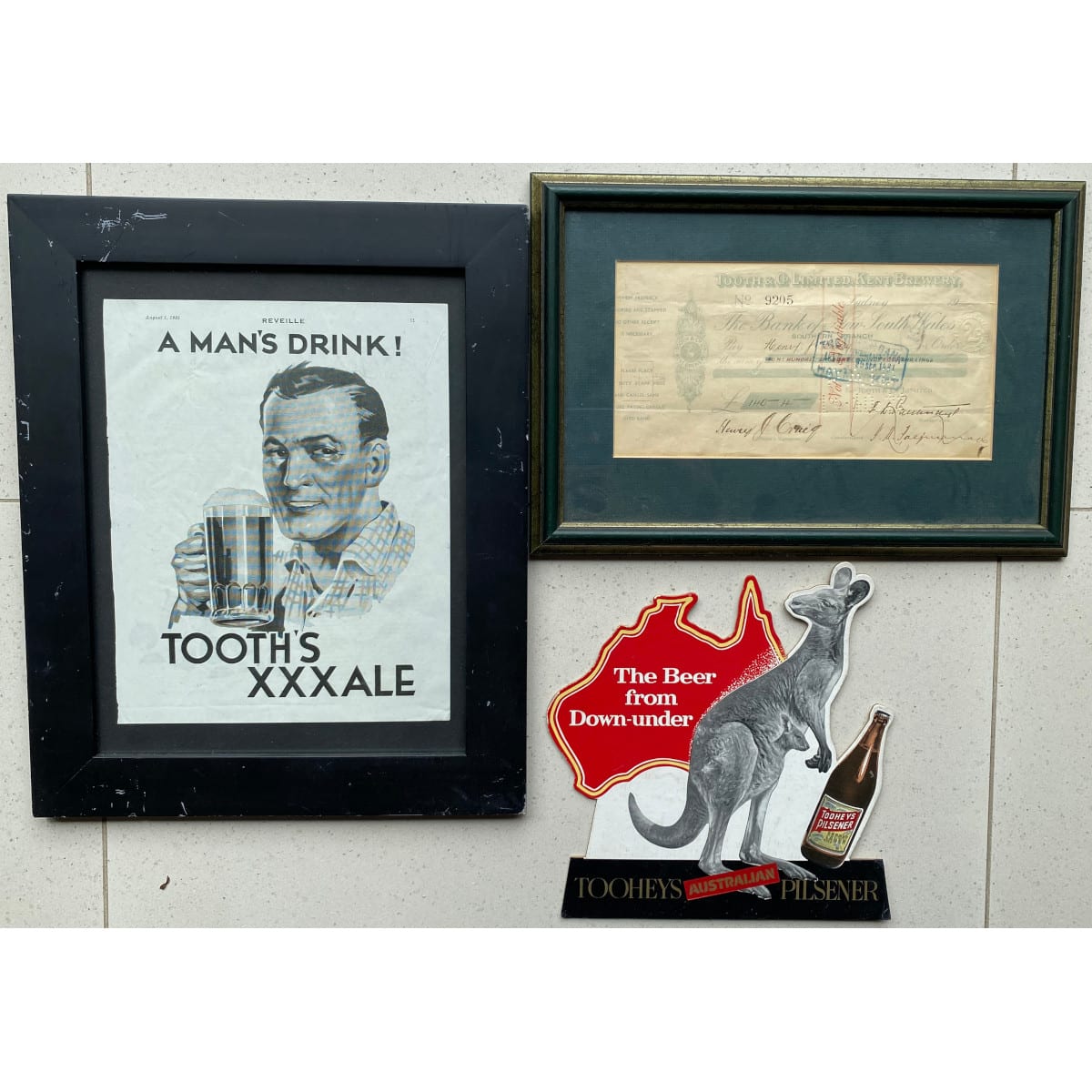 3 Items: Framed 1935 Tooth's XXX Ale advert Framed original Tooth & Co Kent Brewery Cheque Original unused Tooheys Pilsener Kangaroo Counter top display.