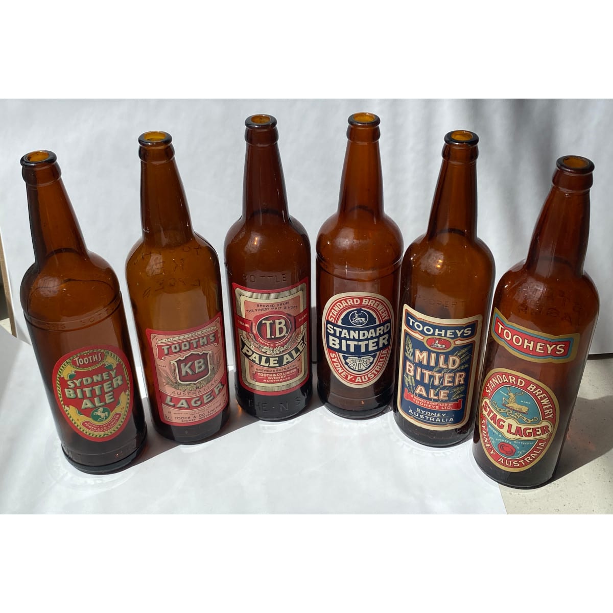 6 labelled beer Bottles: 3 x Tooths 3 x Tooheys. Standard Bitter Ale Sydney Bitter Stag Lager KB & TB Ales etc. (New South Wales)