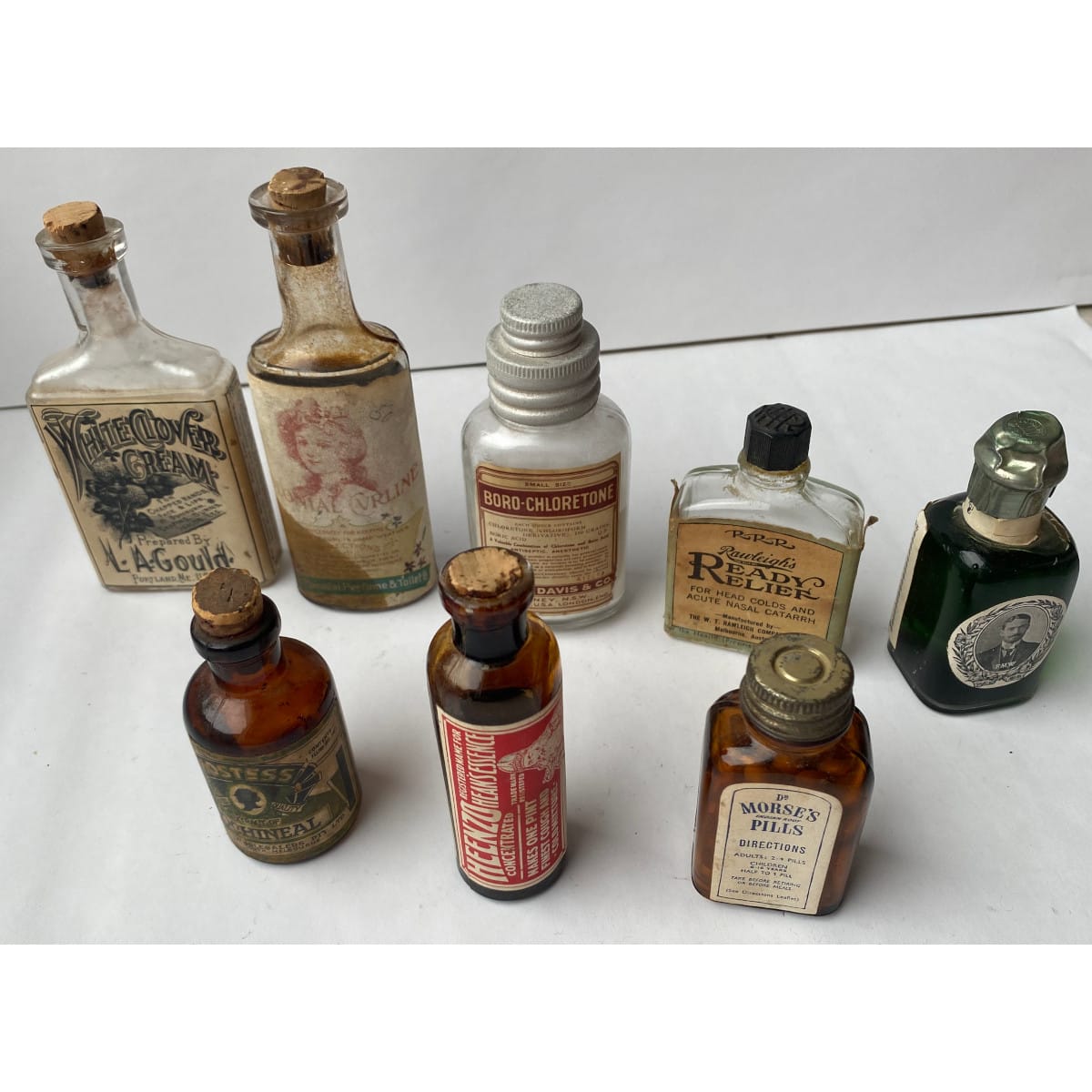 8 small Labelled Bottles: Gould White Clover Cream Colonial Perfume Co Parke Davis Heenzo Dr Morses Pills Hostess Rawleighs Brilliantine.