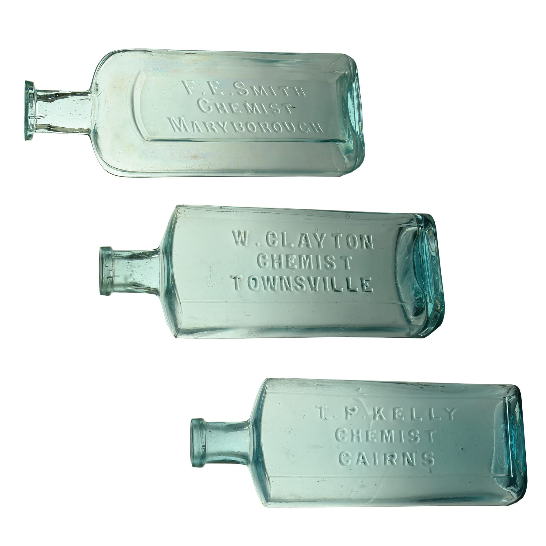 3 Chemists. F. E. Smith, Maryborough. Whitall Tatum. Aqua. 10 oz. 178 mm; W. Clayton Townsville. Blue Aqua. Maws base mark. 8 oz. 163 mm; T. P. Kelly, Cairns. Maws base mark. Blue Aqua. 8 oz. 163 mm. (Queensland)
