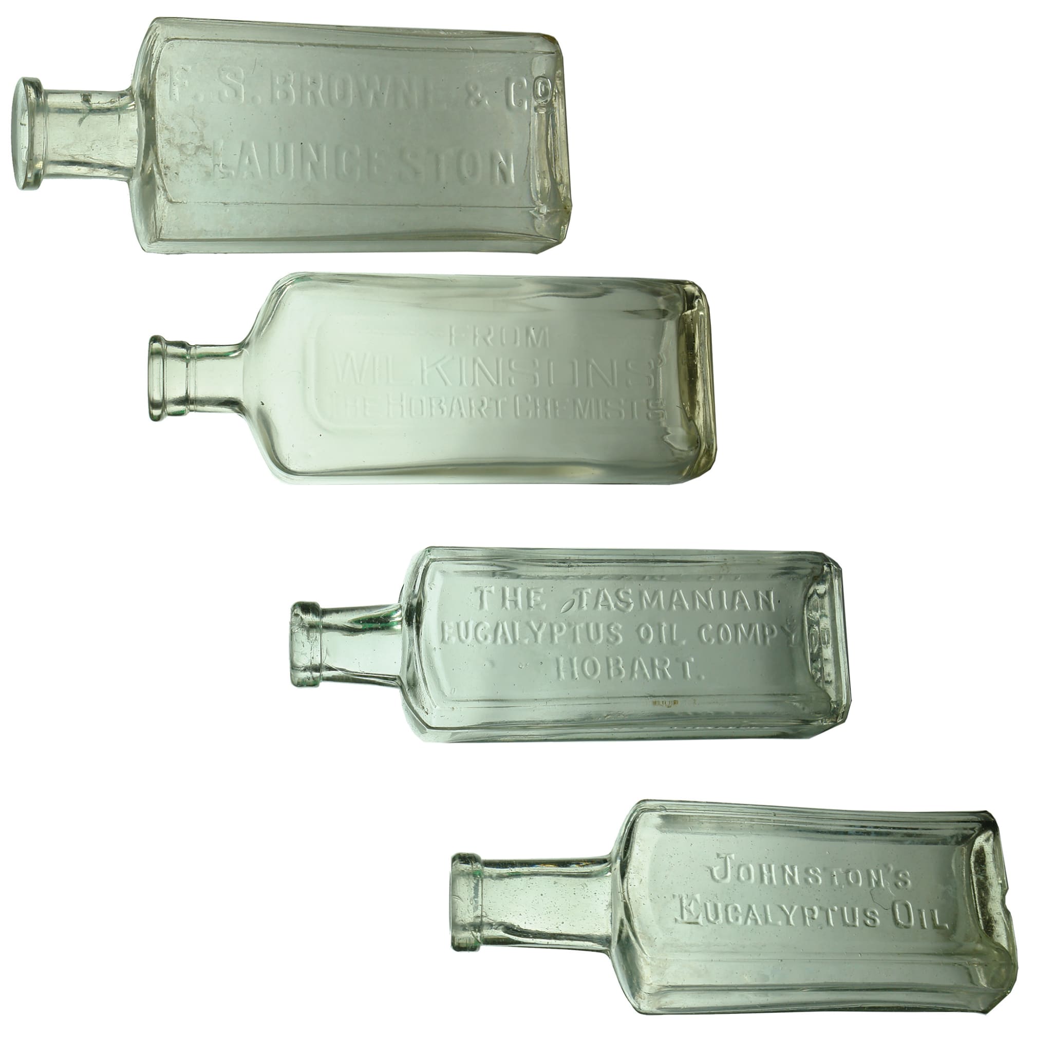 4 Chemist/Eucalyptus Bottles. F. S. Browne & Co, Launceston. Clear. 2 oz; Wilkinsons', The Hobart Chemists. Clear. 10 oz; Tasmanian Eucalyptus Oil Company, Hobart, Platypus Brand. Clear. 3 oz; Johnston's Eucalyptus Oil. Clear. 3 oz. (Tasmania)