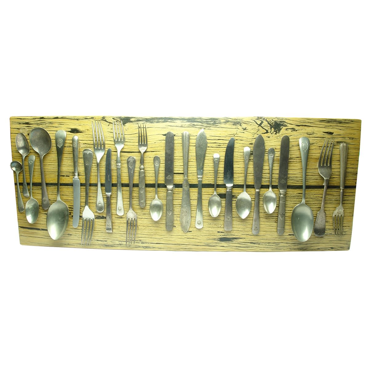 Shipping. 25 pieces of marked shipping cutlery mounted to a board, from Commonwealth Line of Steamers; Huddart Parker Line; Shaw Savill & Albion Lines; B. I. S. N Co Ld; Port Line; M. S. S Co.; The Adelaide Steamship Co Ltd; P&O; PNZ & ARM Co plus others.