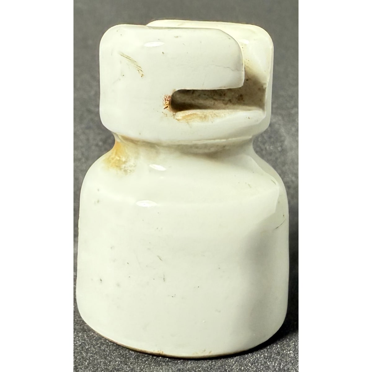 Insulator. White Porcelain bell like with flat top and hooked notch across the top. 50 mm.