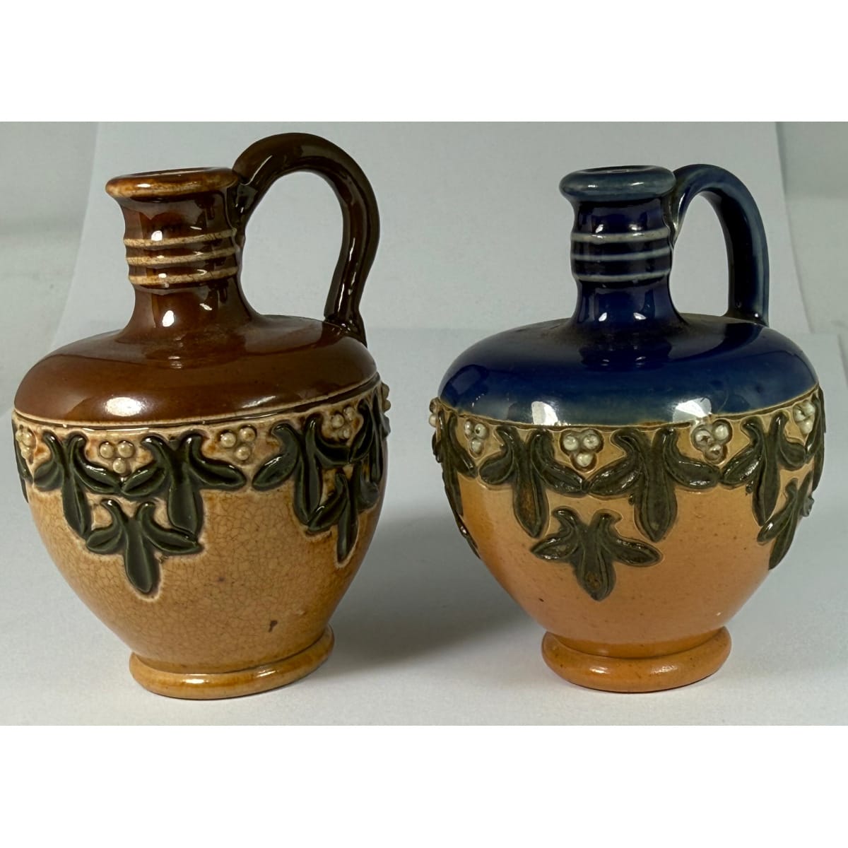 2 Miniature or Sample Royal Doulton Handled Jugs. Blue top and Chocolate Brown top.