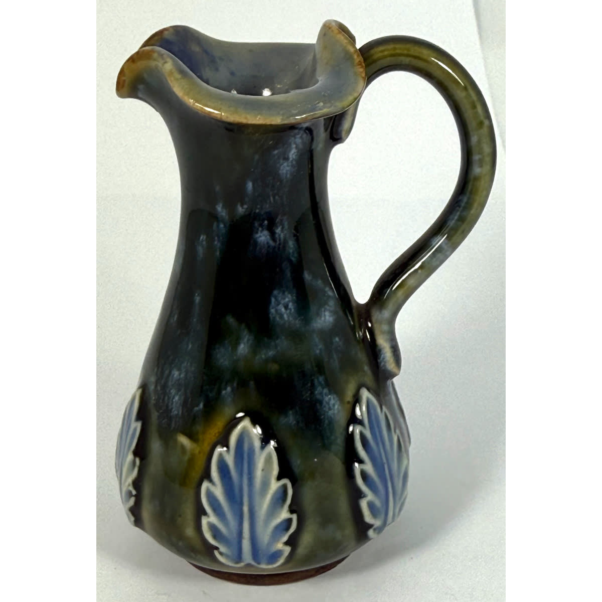 Mini Royal Doulton jug with handle. Fancy top. Blue Green with Flower Decoration.