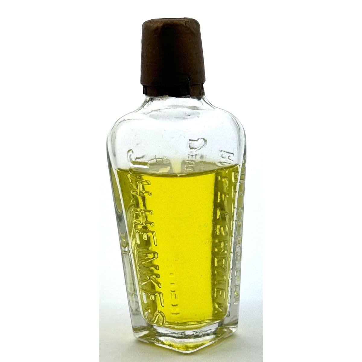 Sample Gin. J. H. Henkes, Delftshaven Rotterdam.  Stork embossed. Original cap and most of contents. Clear.  2 oz. 109 mm.