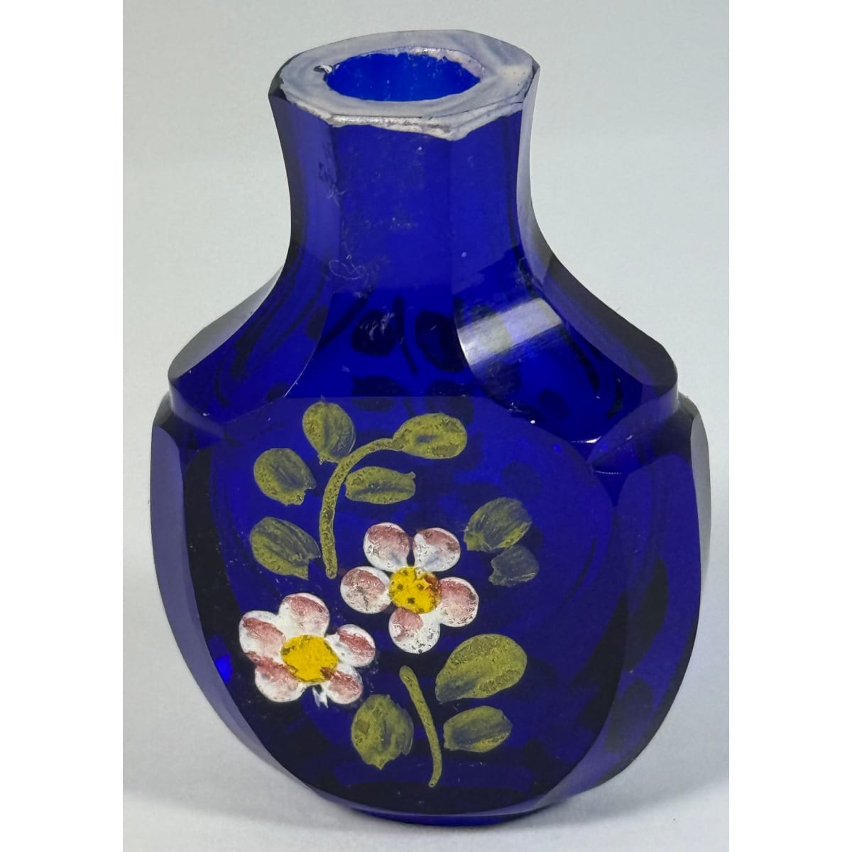 Tiny cut glass scent bottle. Cobalt blue with hand painted floral decoration. 40 mm.