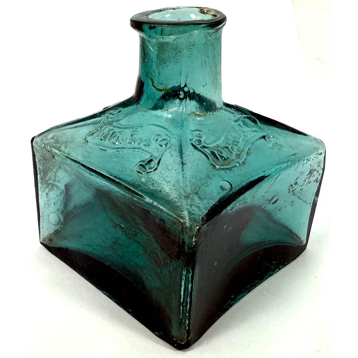 Ink. M & C. Ltd in a ribbon design on all four shoulders. Large square ink. Dark Aqua. Crude lip and base.