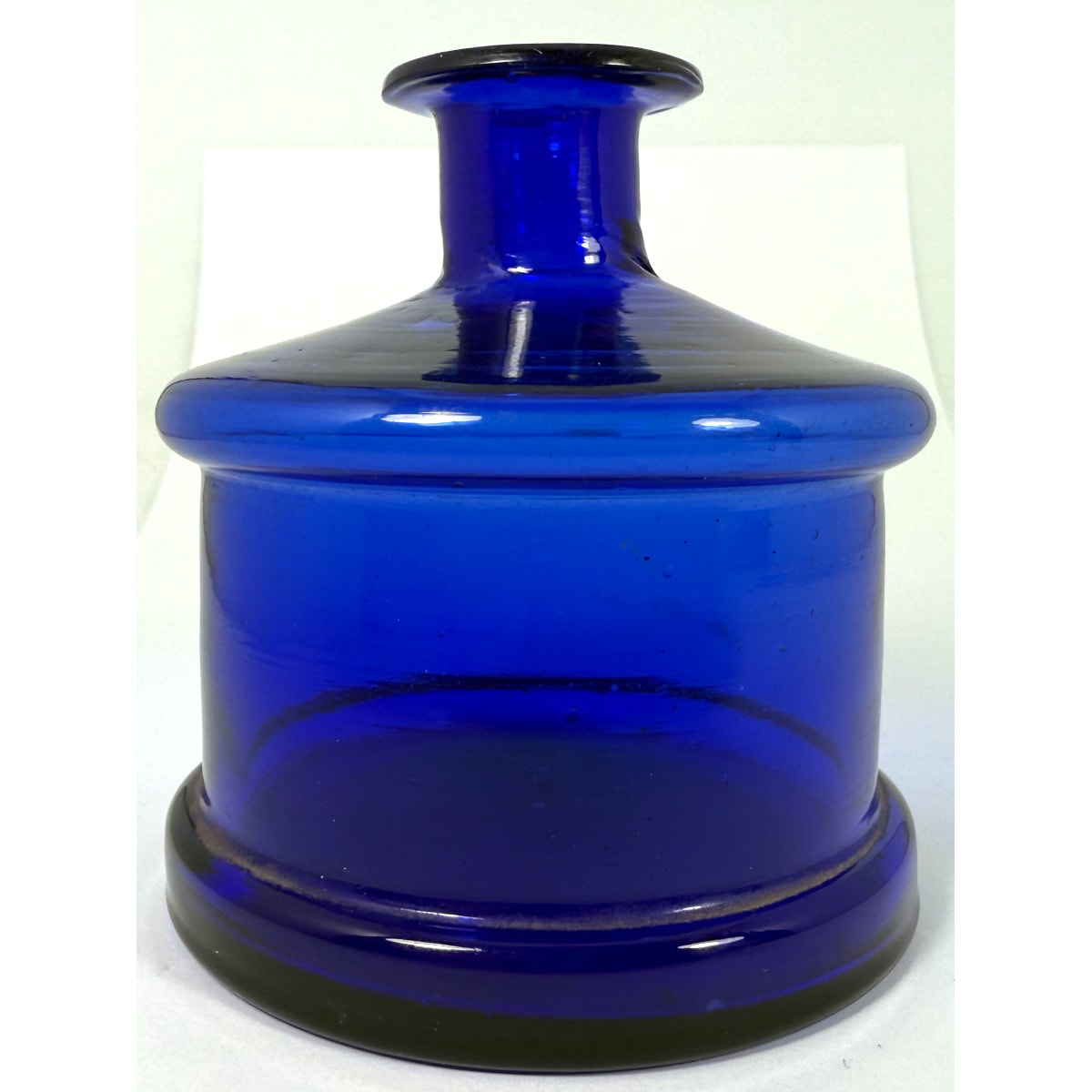 Ink. Large Cobalt Blue Cotton Reel shape. Thin lip. Pontil scar to base.