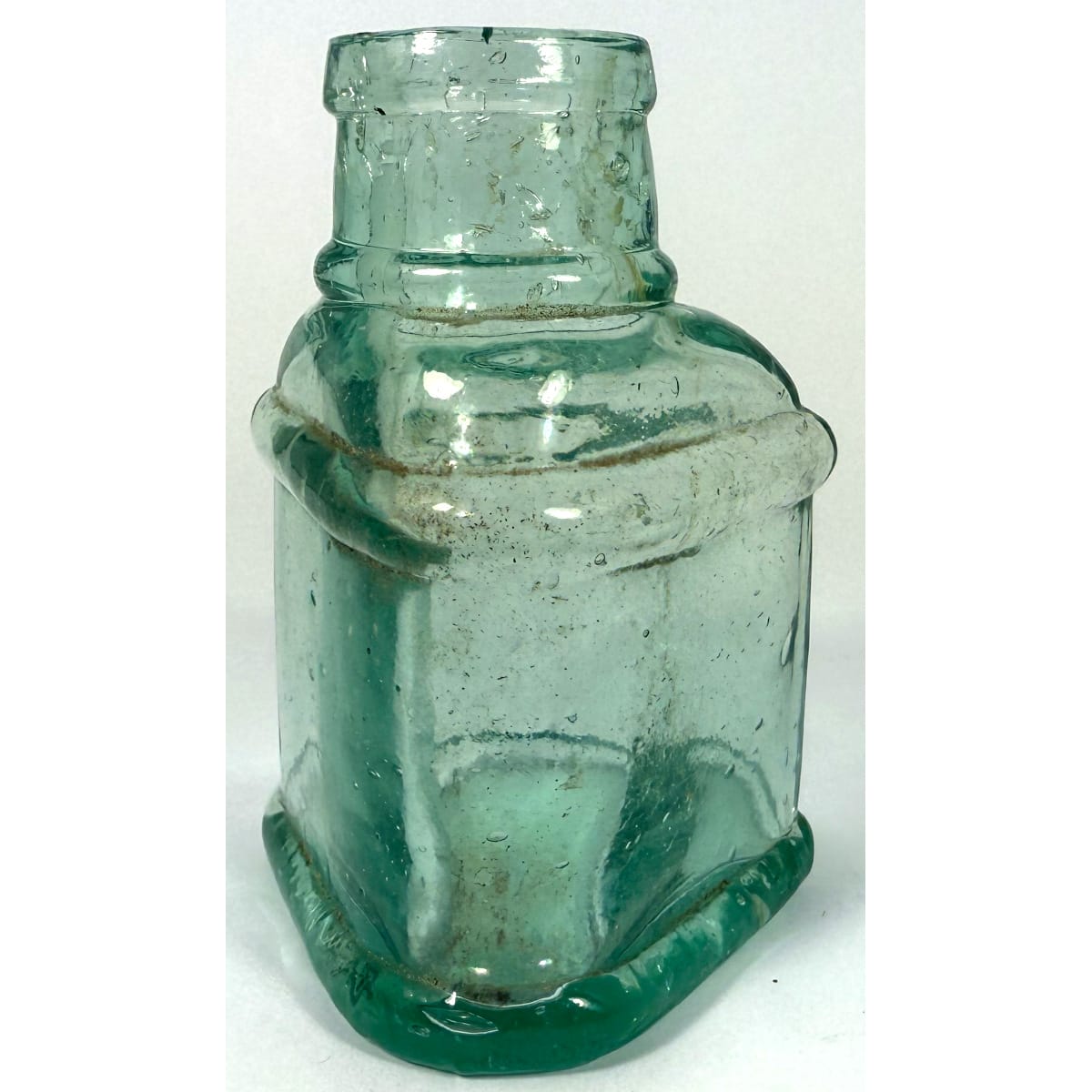 Ink. Wedge shaped with wide mouth top and large ridges around base and shoulder. Aqua. 82 mm.
