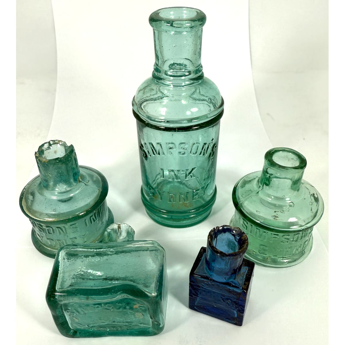 5 Simpsons Sydney Inks (& Cement). Larger one; 2 x different Cotton Reels; Base embossed boat ink and blue glass cement. (New South Wales)