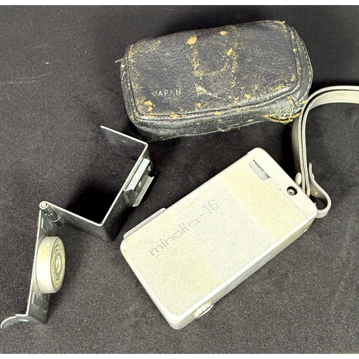 Camera. Minolta 16 "Spy" camera with wrap around flash attachment and leather case.