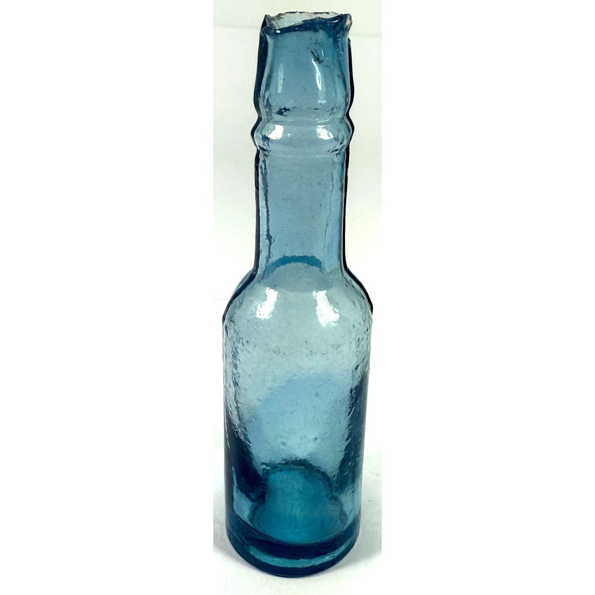 Mini shear top Castor Oil. No base mark. Pale Blue. Half Ounce. 97 mm.