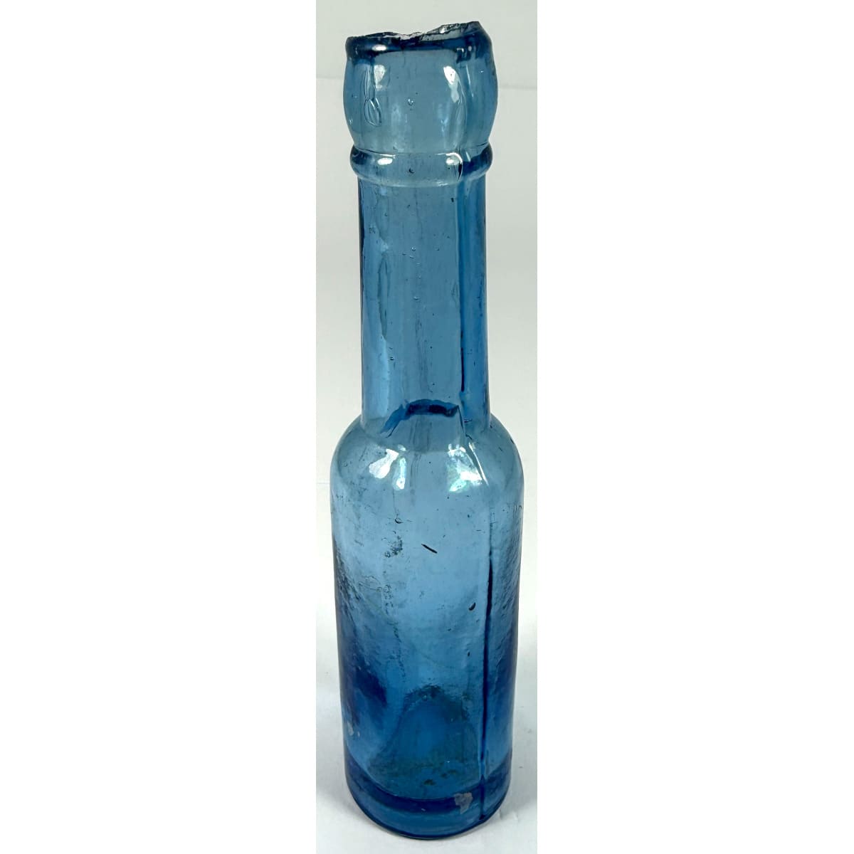 Mini shear top Castor Oil. No base mark. Pale Blue. One ounce. 122 mm.