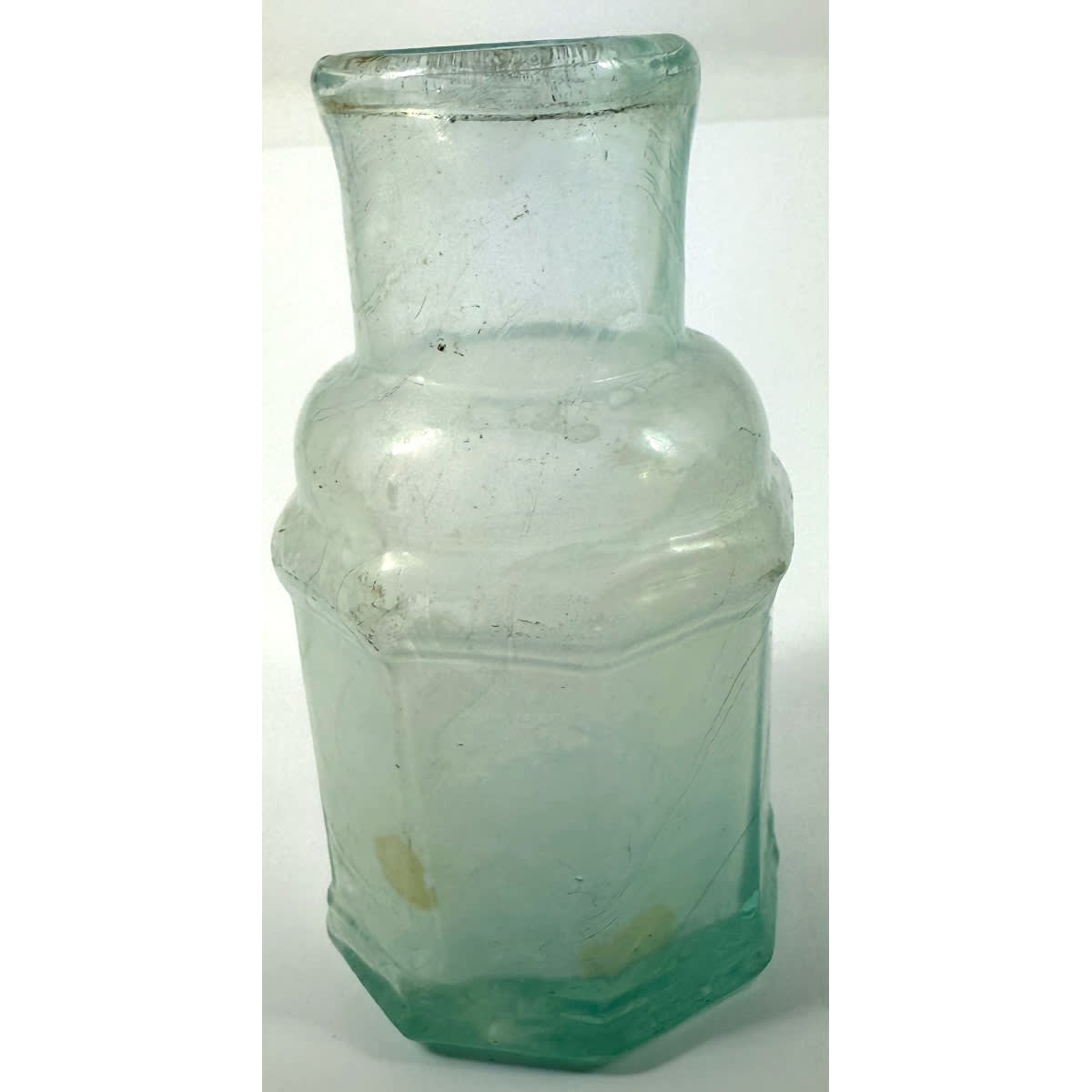 Goldfields. Octagonal wide mouth jar with ridged base and shoulder. Sharp tube pontil scar. Mini size. About 1.5 oz. 79 mm.