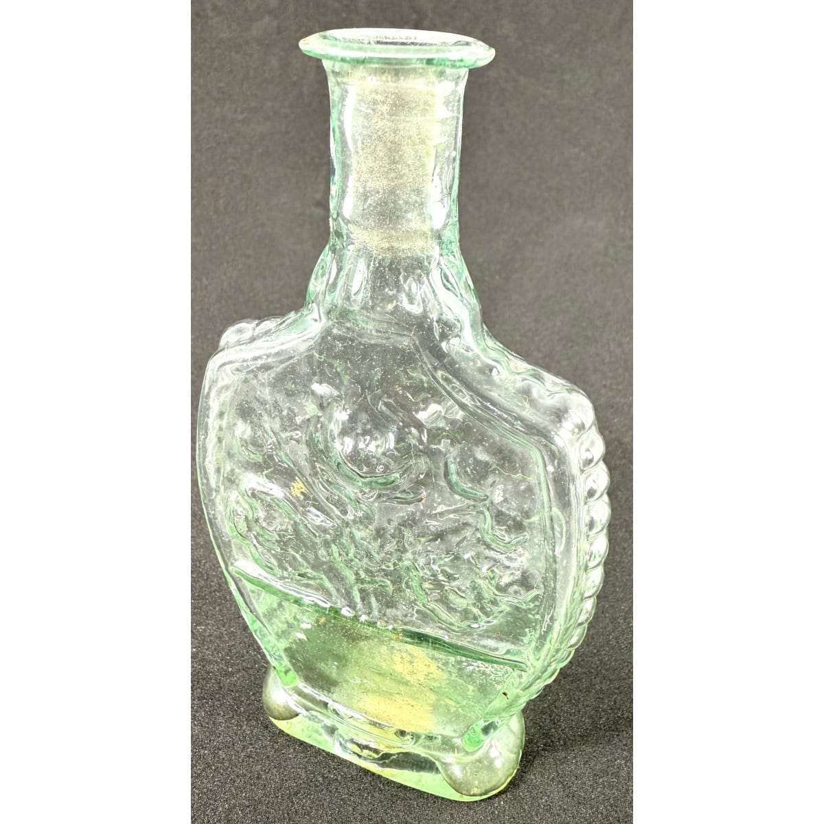 Goldfields Cologne. Fancy flat flask shape. Flowers on both sides. Ridged edge. Thin lip. Tube pontil scar to base. 2oz. 110 mm.