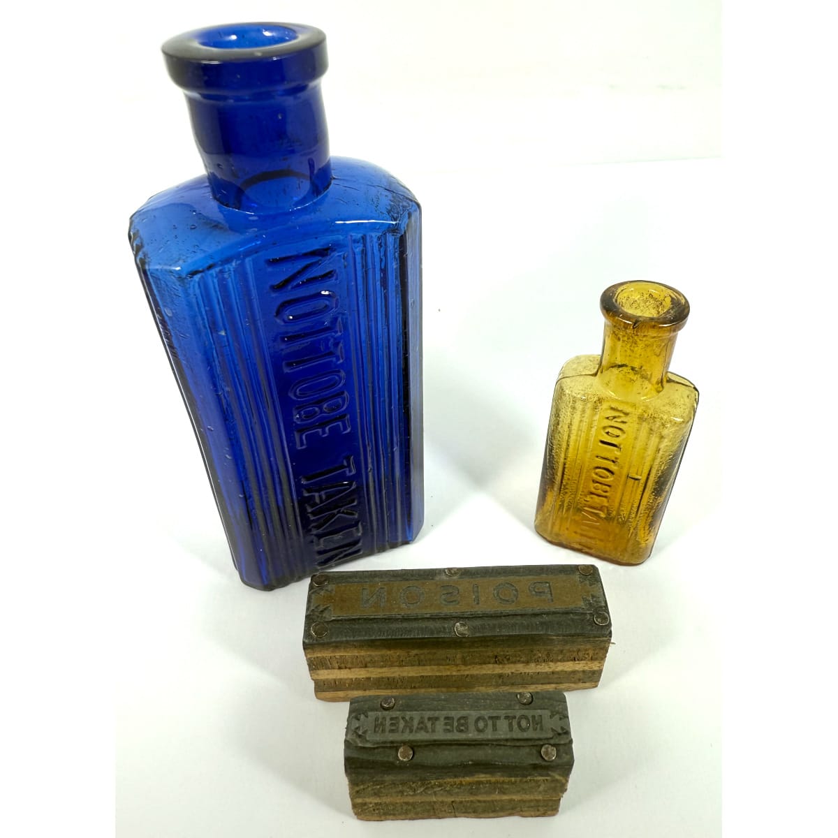 4 Items: 2 Printers blocks with "Poison" and "Not to be Taken"; 2 oz Blue Poison; 0.5 oz Honey Amber Poison.